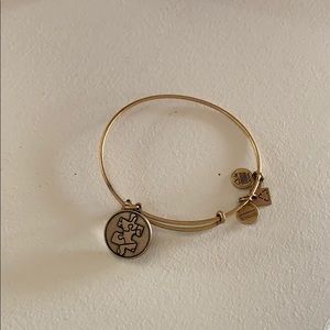 Alex and Ani gold bracelet with puzzle charm